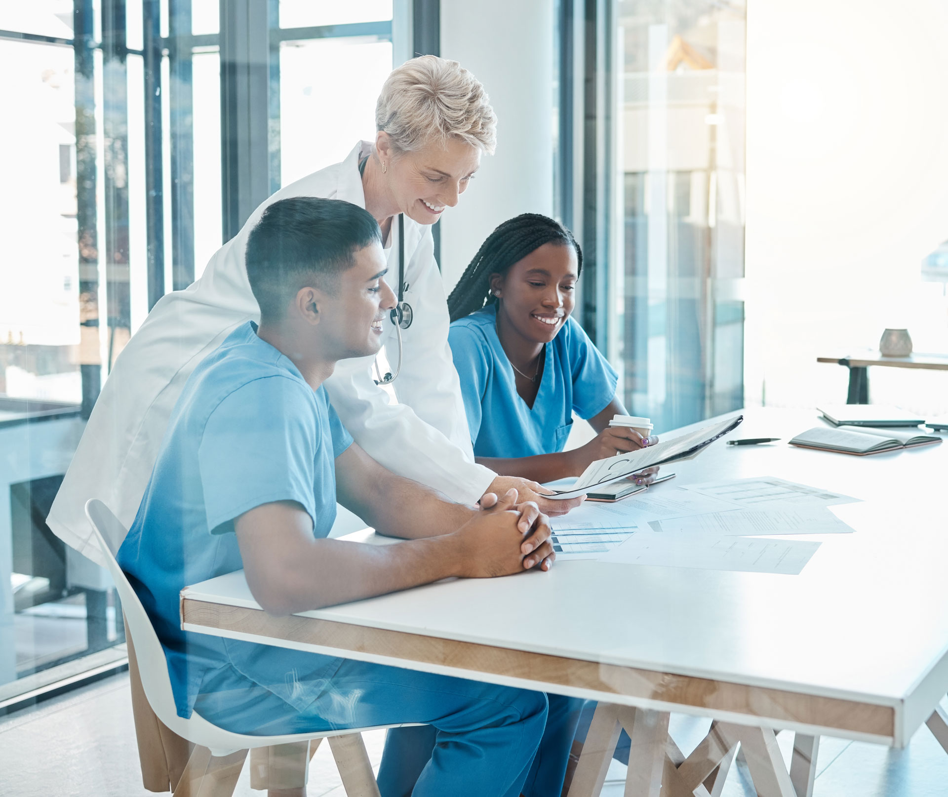 Diverse team of medical professionals strategizing workflow. Depicting medical team management